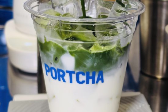 Fresh matcha being poured into a Portcha iced matcha latte