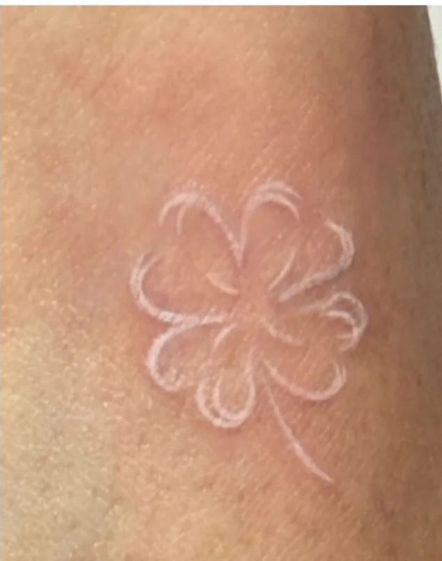 The same clover design in white ink, blending softly into the skin