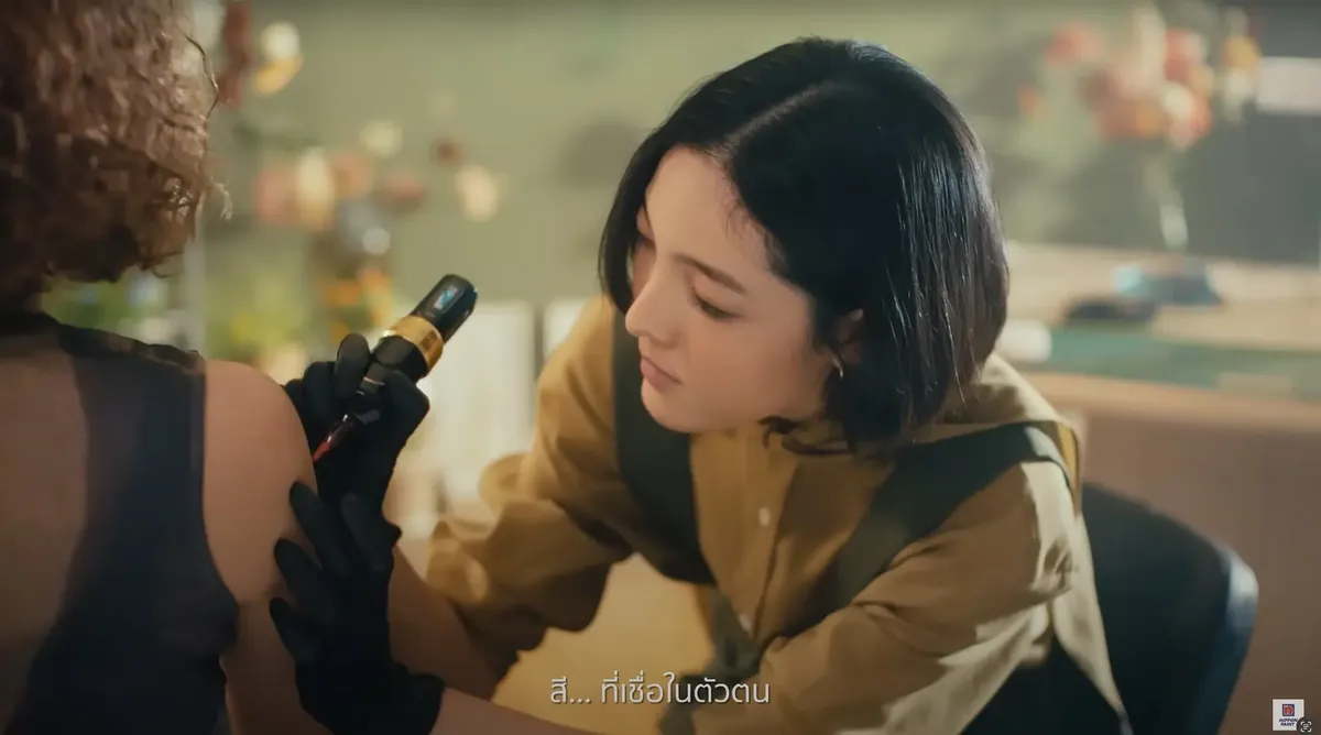 Tattooing a flower design on the actress during filming