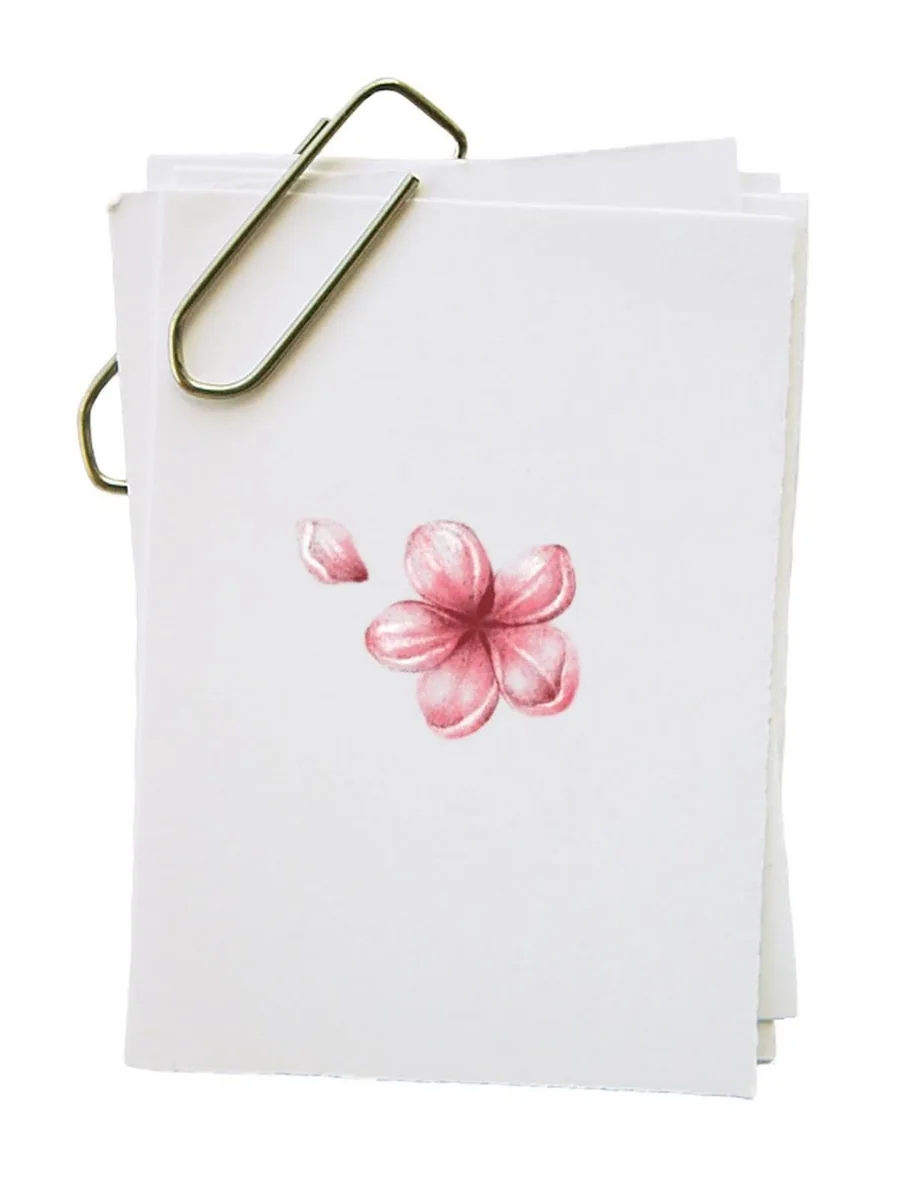 The original pink flower drawing on a small paper card held by a paperclip