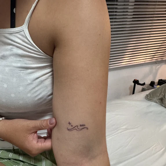 The wave tattoo on an upper arm in the studio